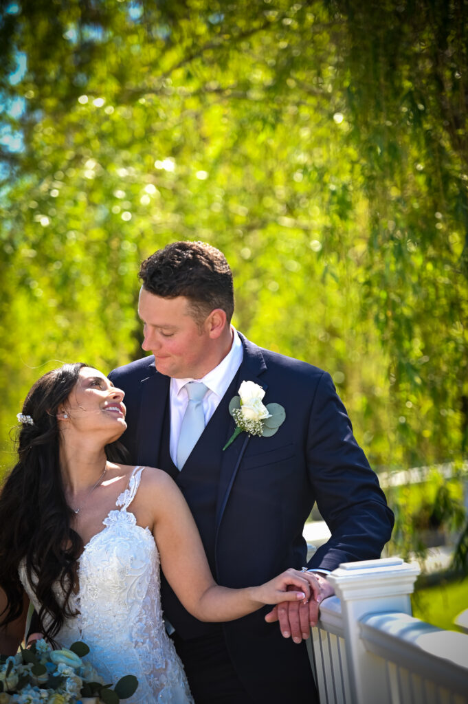 Bride and groom romantic portrait by waterfall at Flowerfield
