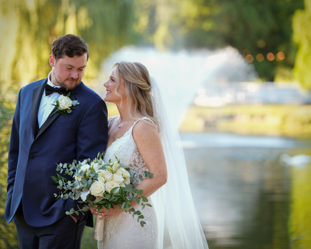 Bride and groom portrait by lake at Flowerfield Long Island