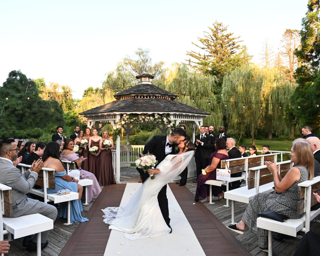 Bride walking down aisle toward gazebo at Flowerfield ceremony