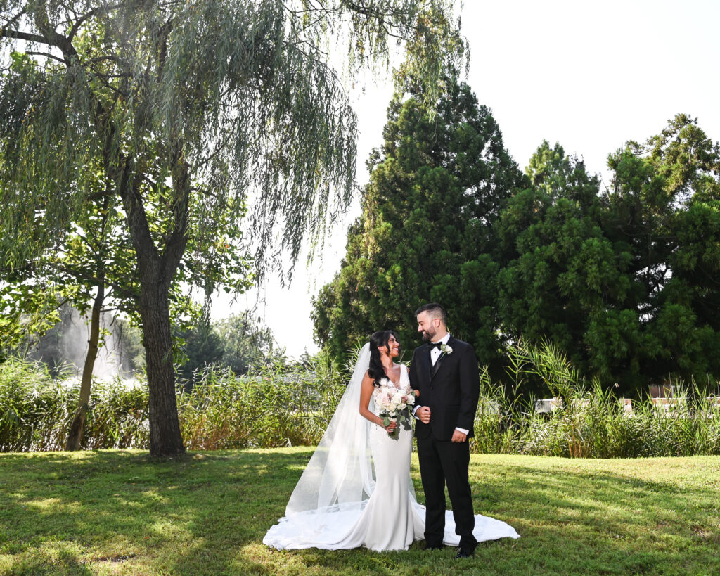 Bride and groom full length portrait in gardens at Flowerfield wedding venue