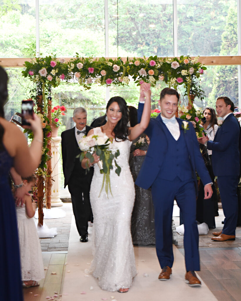 Bride and groom walking down aisle at Flowerfield outdoor ceremony