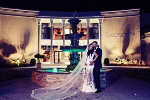 Bride and groom nighttime portrait in front of Leonard’s Palazzo in Great Neck, NY