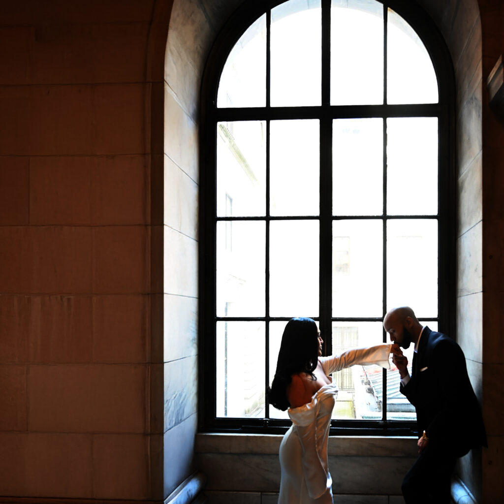 Beautiful African American couple photographed during their engagement session at the New York Public Library in New York City.