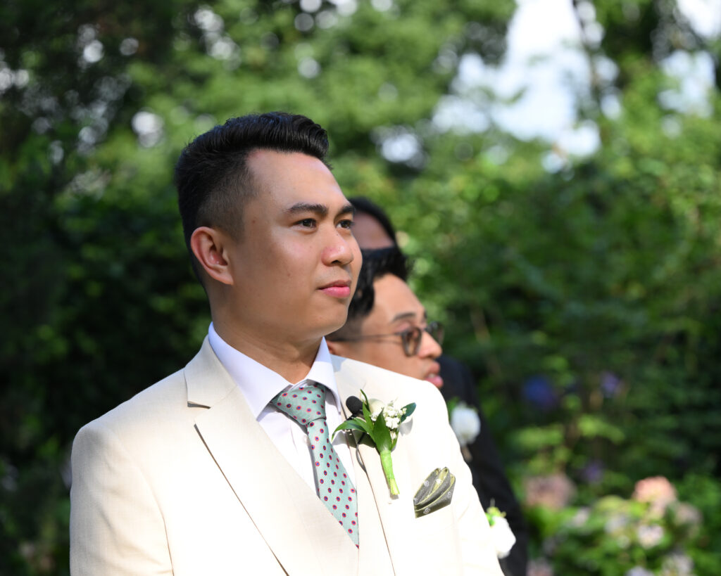 Groom portrait in Westbury Manor gardens before ceremony in Long Island NY