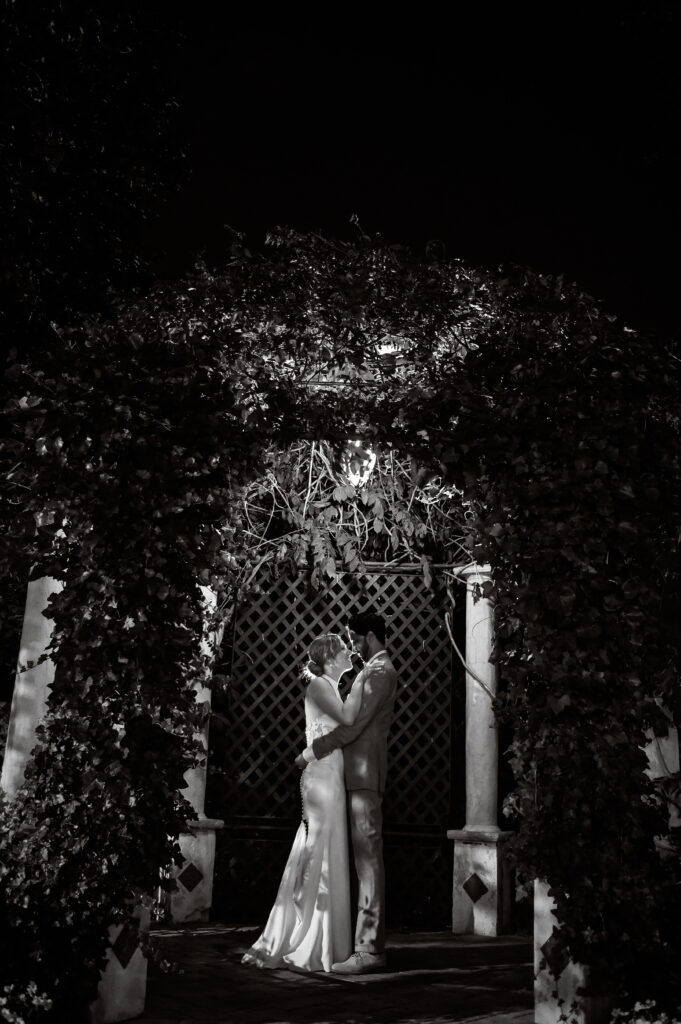 Bride and groom entering reception at night with dramatic lighting at Long Island venue
