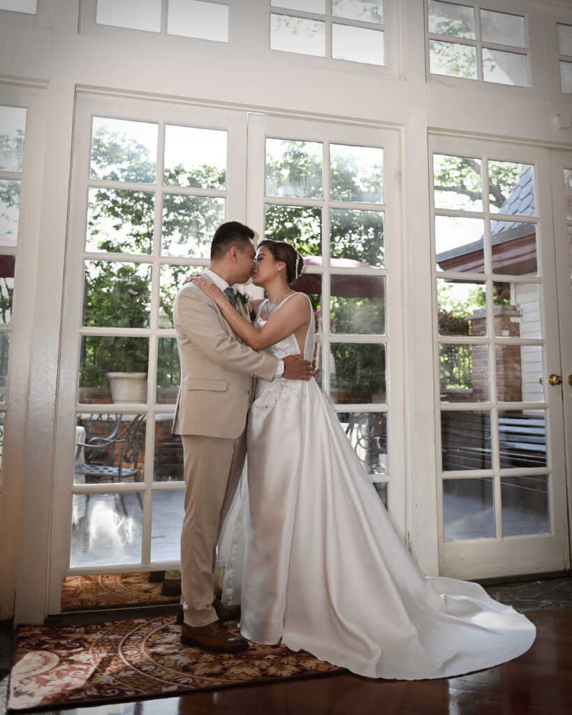 Bride and groom first dance near large windows at Long Island wedding venue at Westbury manor
