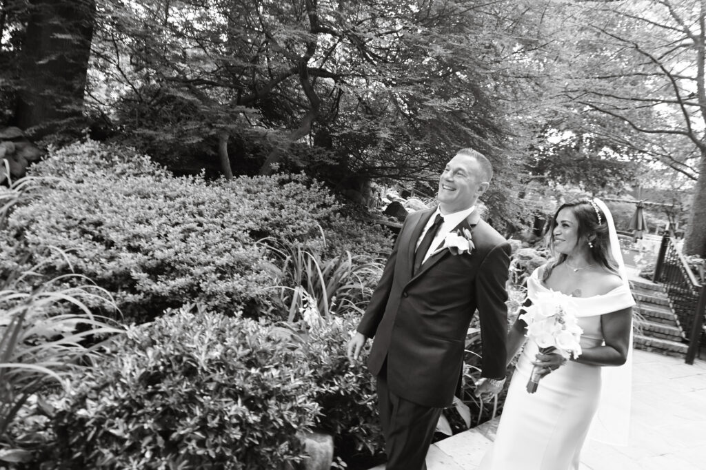 Bride and groom celebrating in Westbury Manor gardens Long Island NY
