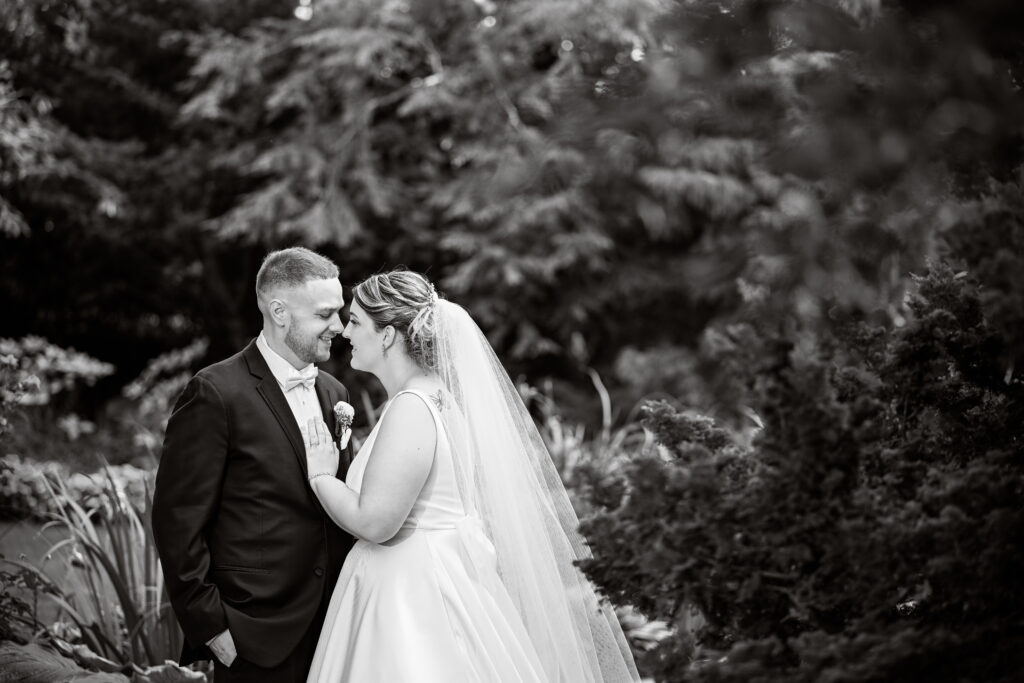 Bride and groom close portrait in Westbury Manor outdoor gardens