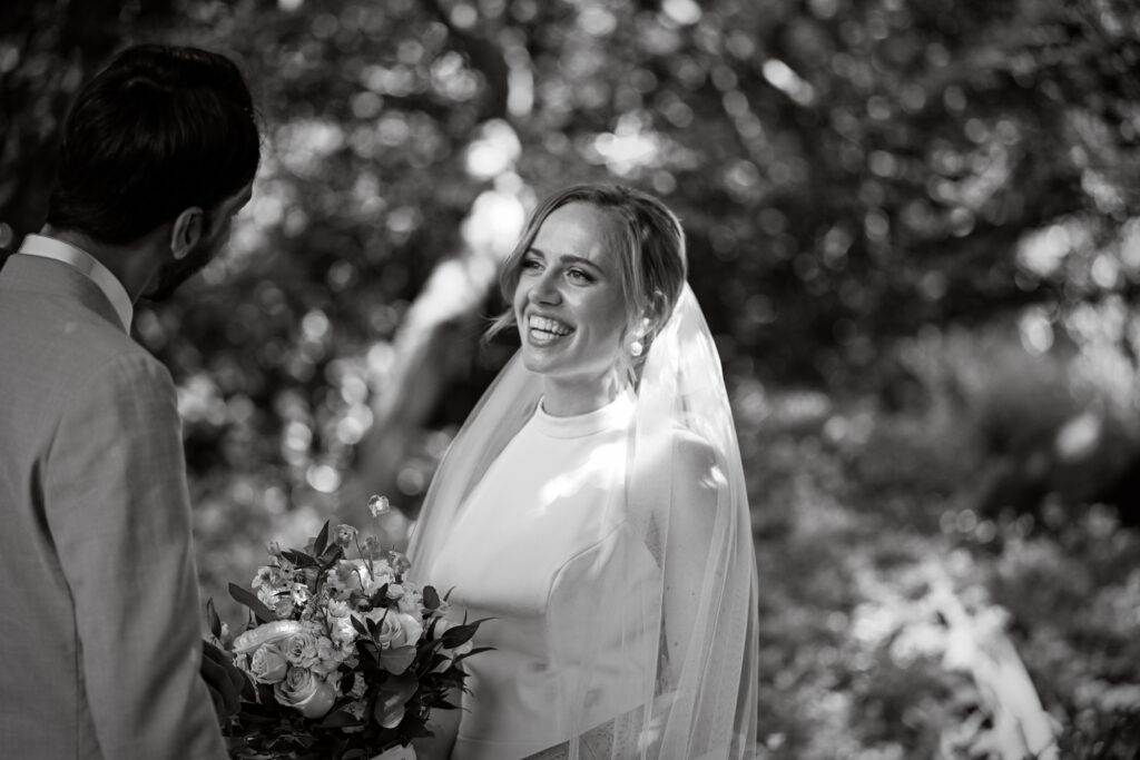 Bride and groom walking along garden path at Westbury Manor Long Island