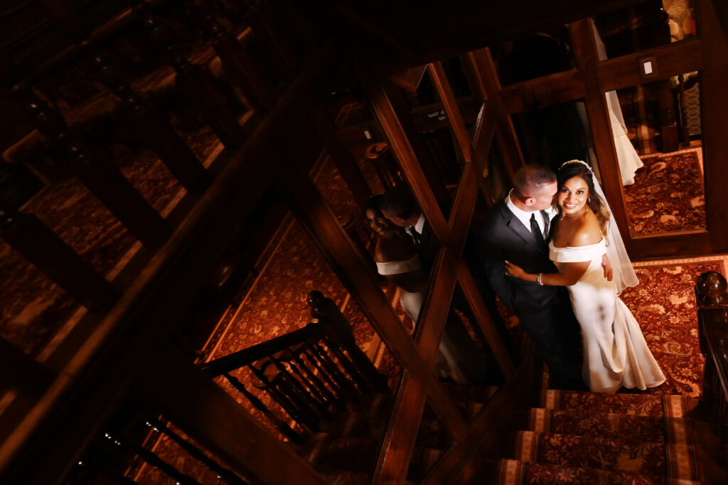 Bride and groom grand staircase portrait inside Westbury Manor