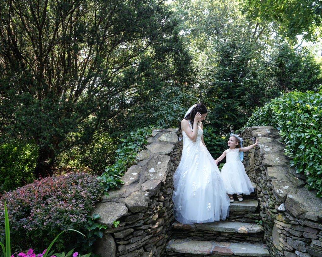 Bride and groom on stone garden steps at Westbury Manor wedding