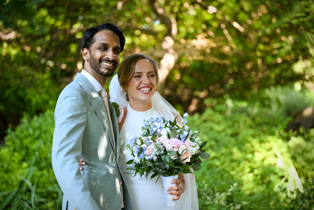 Bride and groom smiling in Westbury Manor gardens Long Island