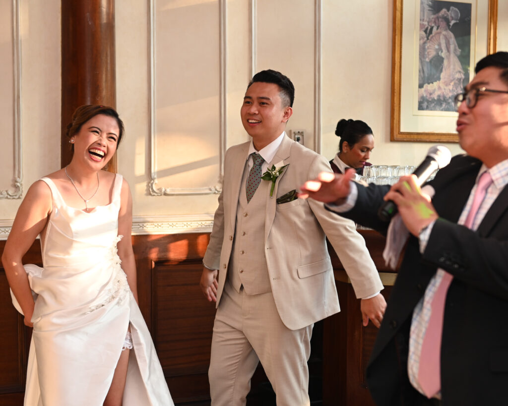 Bride and groom laughing during reception at Westbury Manor Long Island