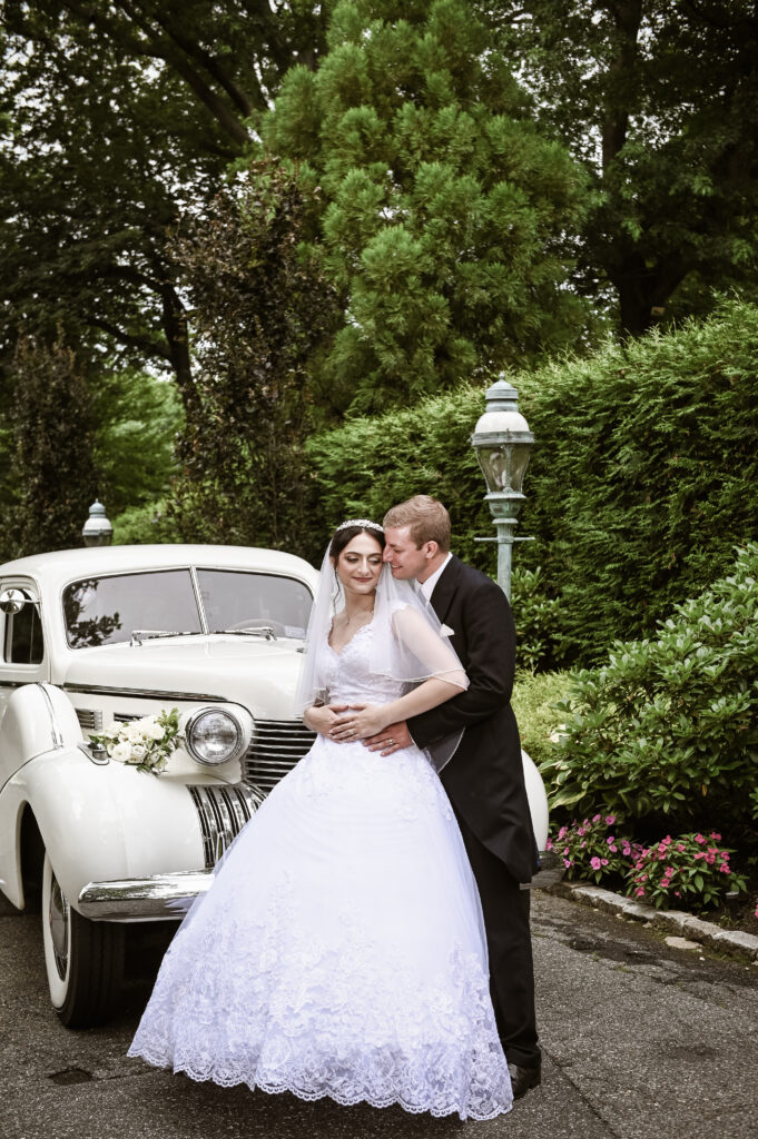 Bride and groom with vintage car at Westbury Manor Long Island wedding