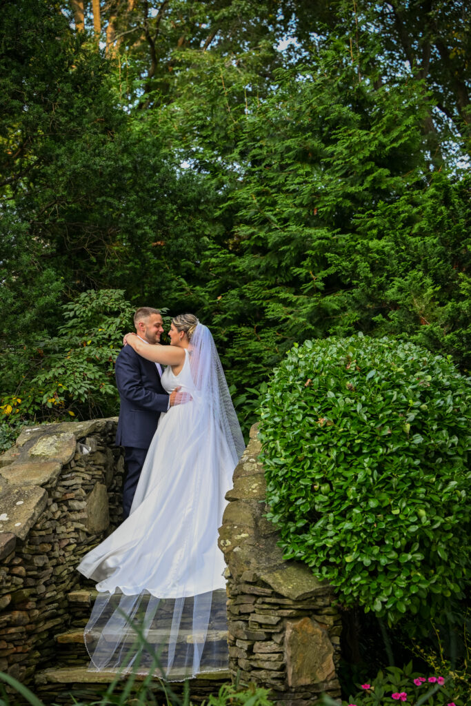 Bride and groom kissing in Westbury Manor gardens Long Island NY