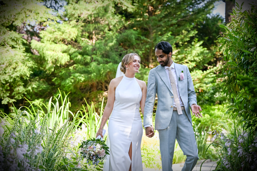 Bride and groom walking through Westbury Manor gardens Long Island NY