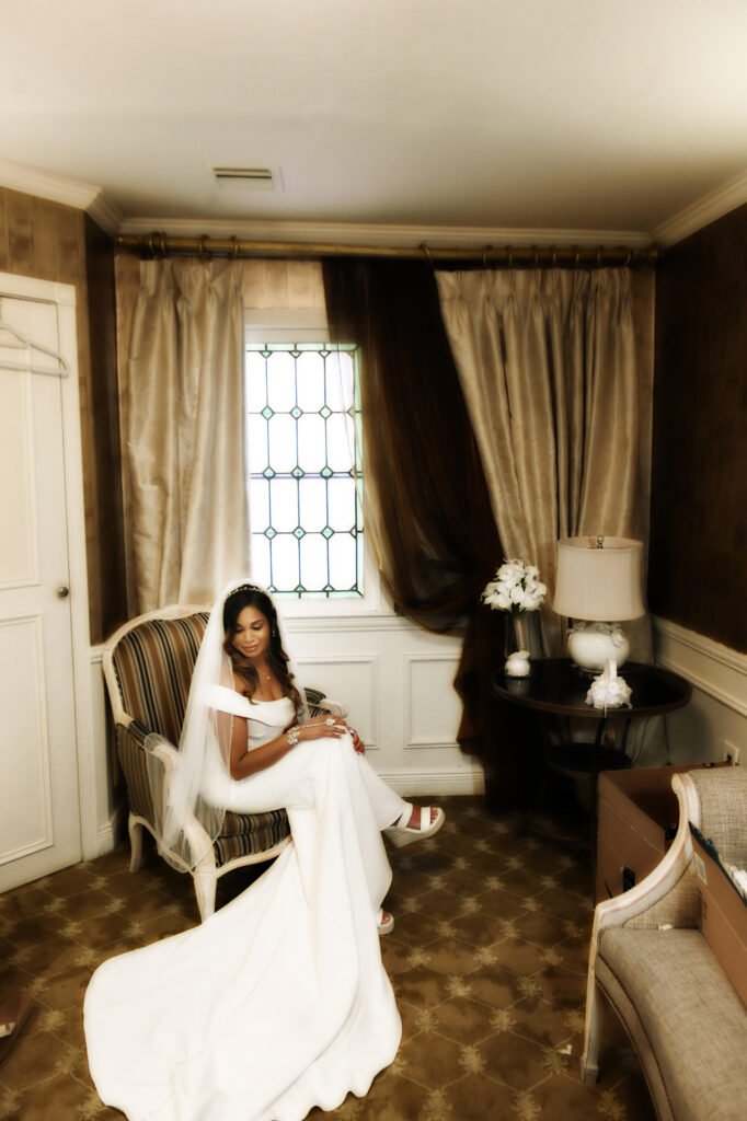 Bride sitting in bridal suite at Westbury Manor Long Island wedding