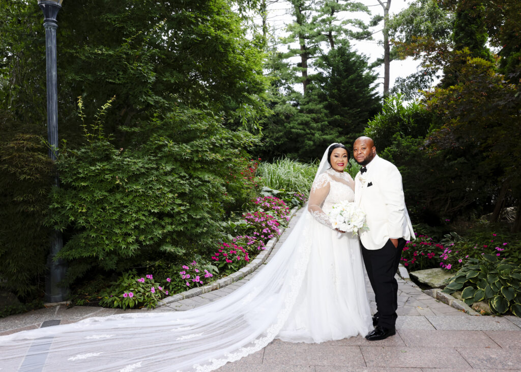 Bride with long veil on Westbury Manor garden path