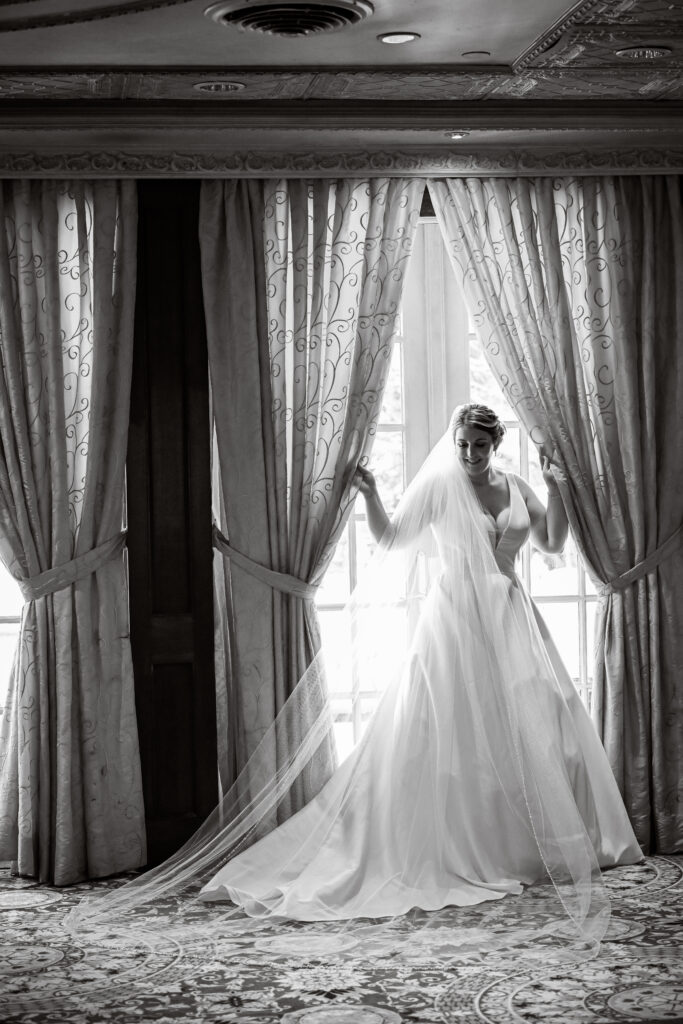 Bride silhouette at window inside Westbury Manor Long Island wedding venue