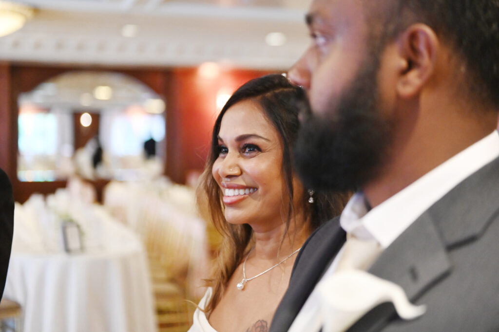 Bride smiling during reception inside Westbury Manor ballroom Long Island