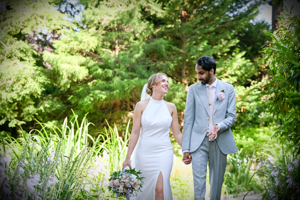 Bride and groom walking through Westbury Manor gardens Long Island