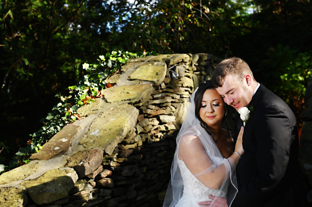 Bride and groom on stone staircase in Westbury Manor gardens