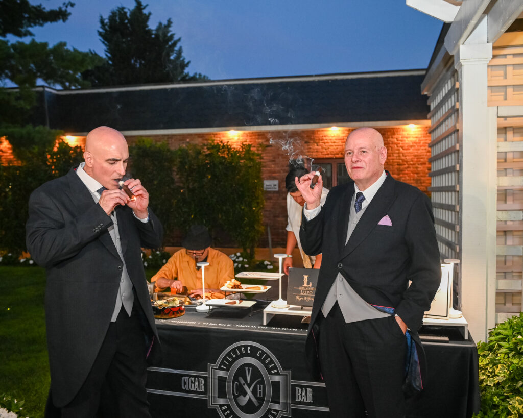 Groomsmen enjoying cocktail hour outdoors at Westbury Manor Long Island wedding