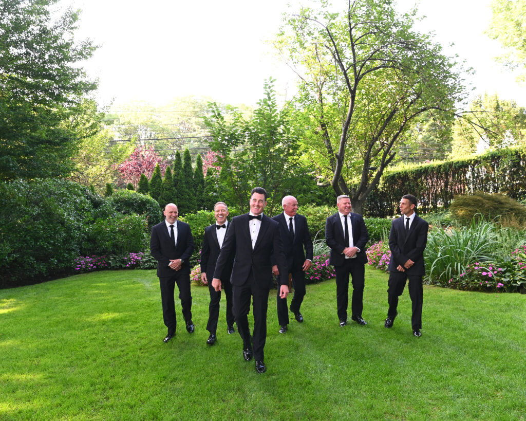 Groomsmen standing in Westbury Manor gardens Long Island wedding