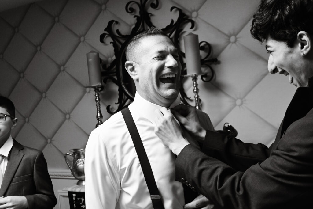 Black and white groom portrait getting ready at Westbury Manor