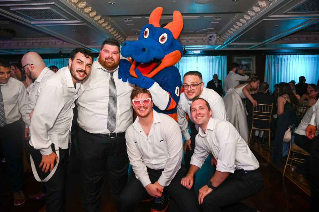 Groomsmen posing with Islanders mascot during Westbury Manor wedding reception