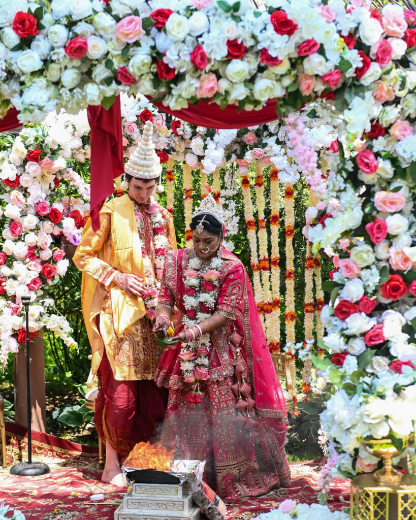 Cultural wedding ceremony with floral backdrop at Westbury Manor Long Island