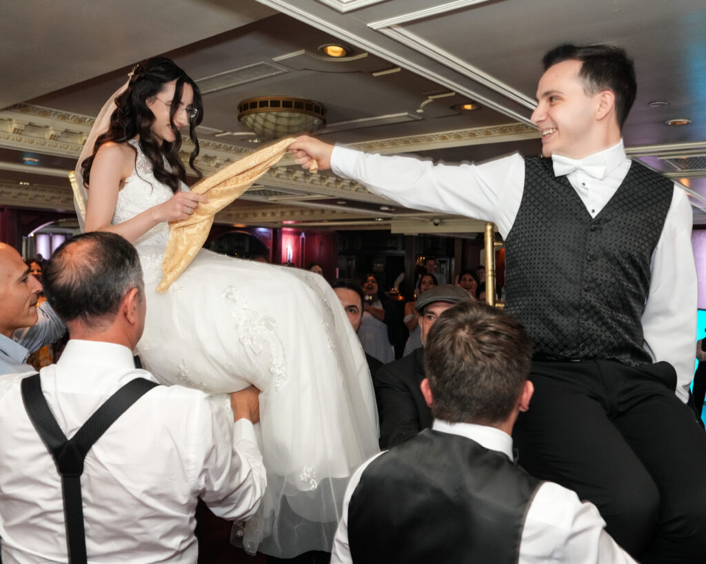 Bride lifted during wedding reception dancing at Westbury Manor ballroom Long Island