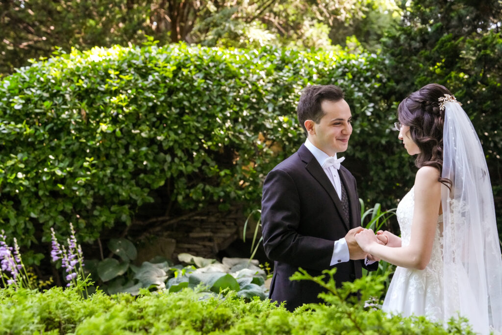 Bride and groom under chuppah in Westbury Manor garden Long Island wedding