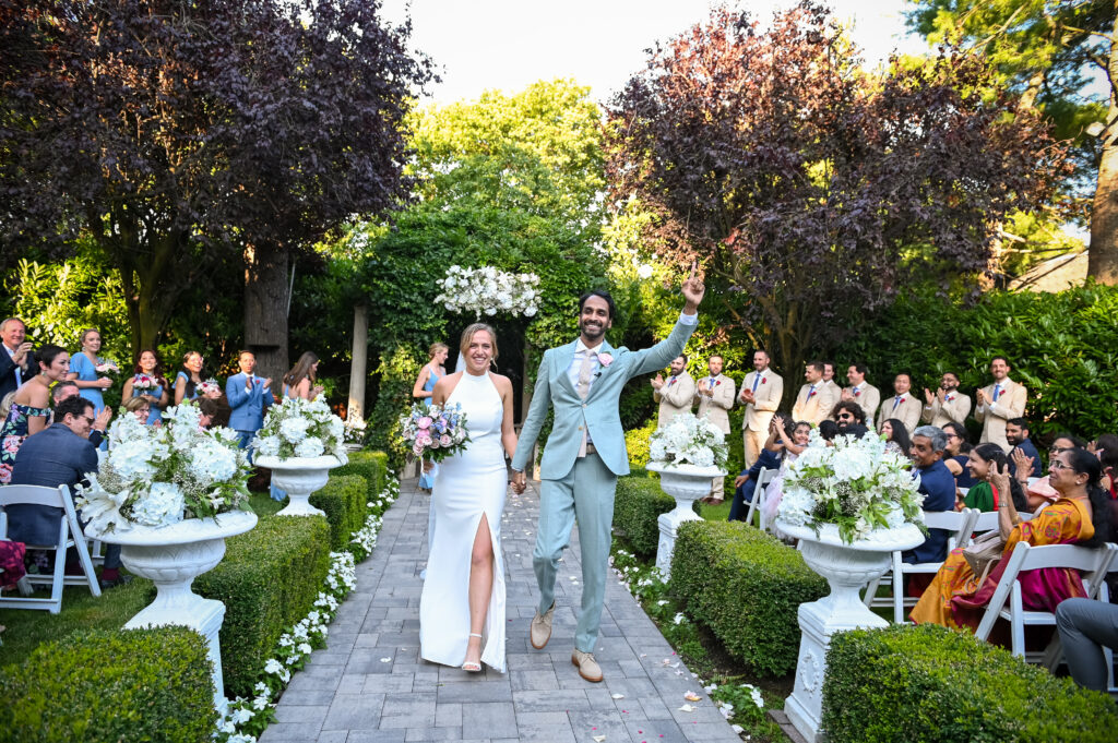 Bride and groom entering reception at Westbury Manor ballroom Long Island