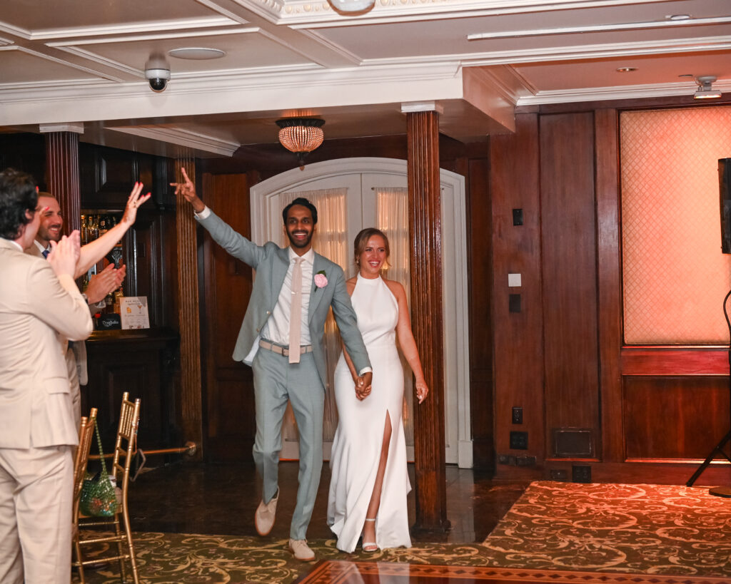 Bride and groom entering reception through doors at Westbury Manor Long Island