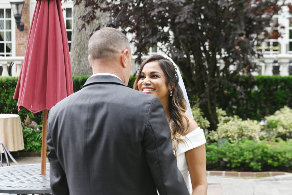 Bride and groom talking in Westbury Manor gardens Long Island wedding
