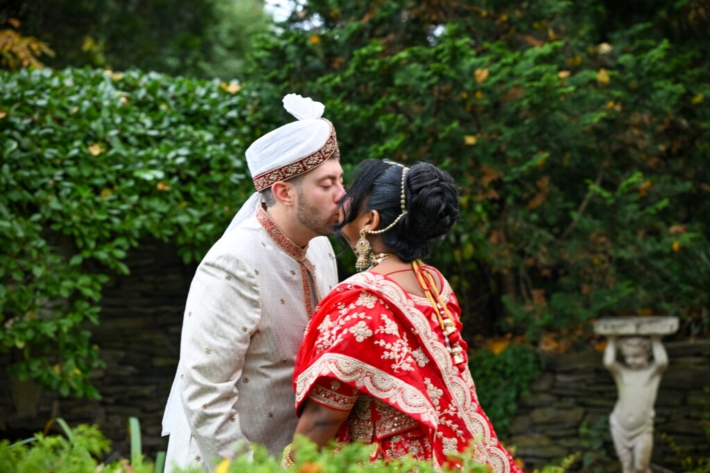 South Asian bride and groom close portrait in Westbury Manor garden