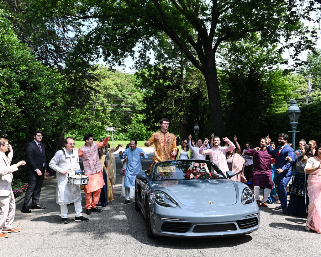 Bride and groom arriving in sports car at Westbury Manor Long Island wedding