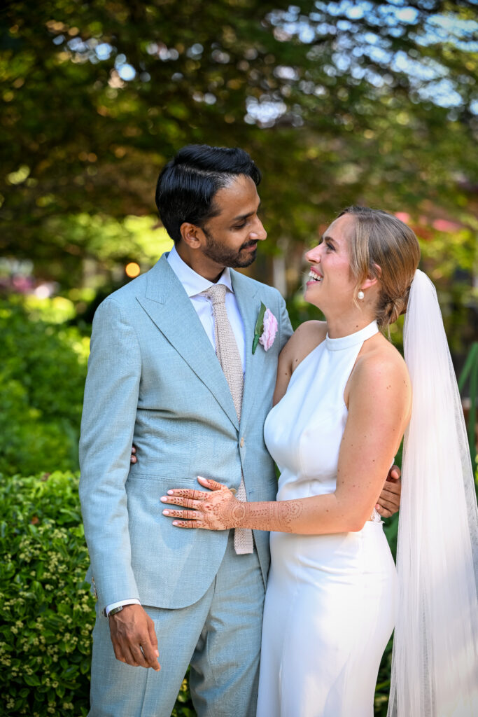 Bride and groom smiling in Westbury Manor garden Long Island wedding