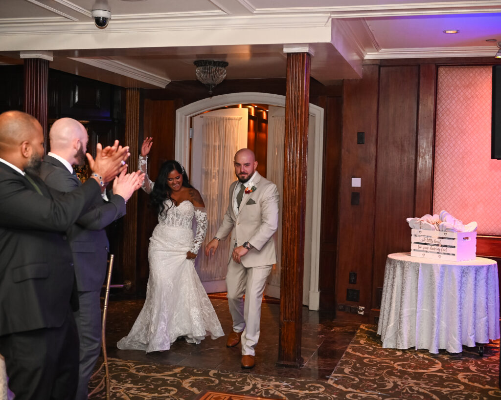 Bride and groom entering Westbury Manor ballroom reception Long Island