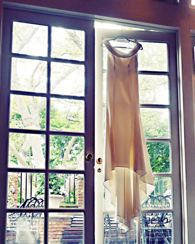 Wedding dress hanging in window at Westbury Manor Long Island wedding venue